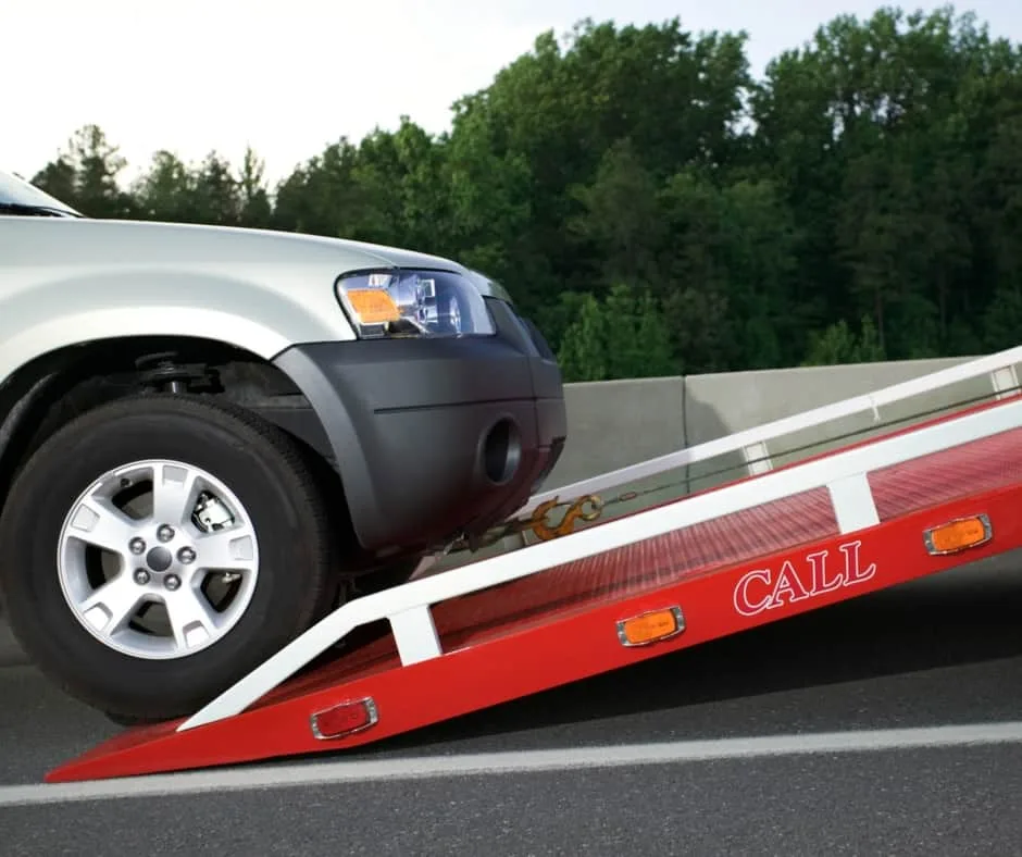 Windsor tow truck loading a vehicle on a residential street