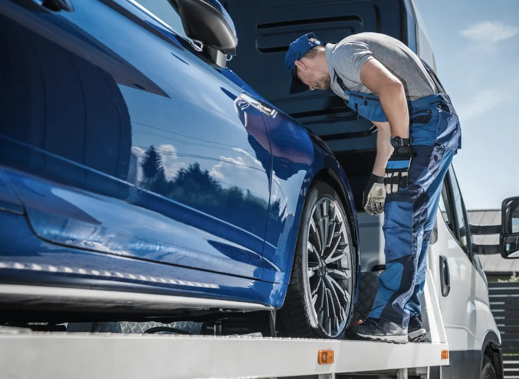 Tecumseh tow truck operator loading vehicle