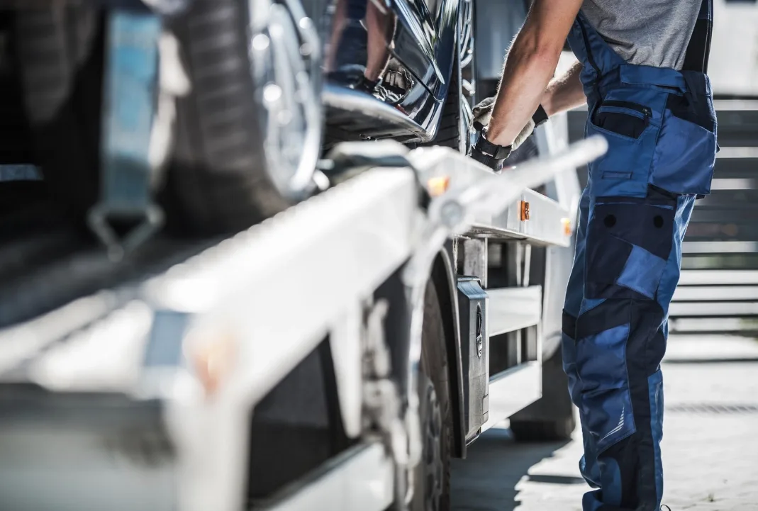 Windsor tow truck driver loading a car onto a flatbed